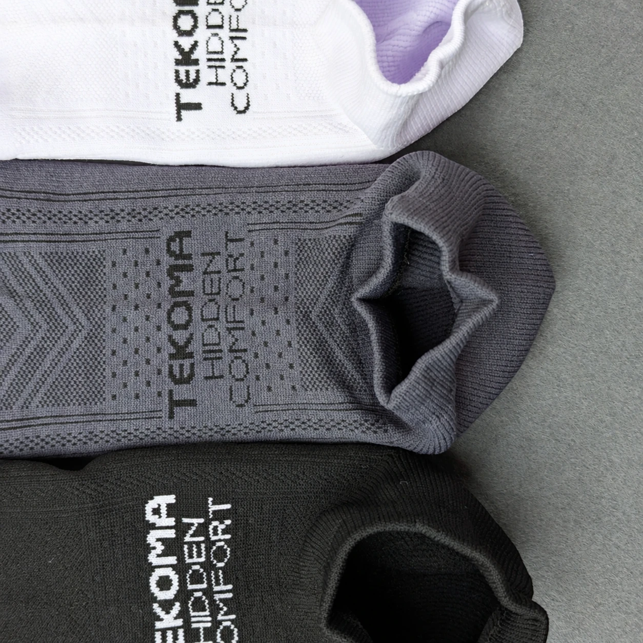 Knit and opening details of Tekoma Hidden Comfort in white, grey and black